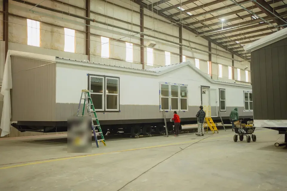 Housing unit being built and set by a Texas factory crew
